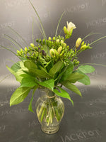Mixed freesia dozen bouquet arranged in a vase.
